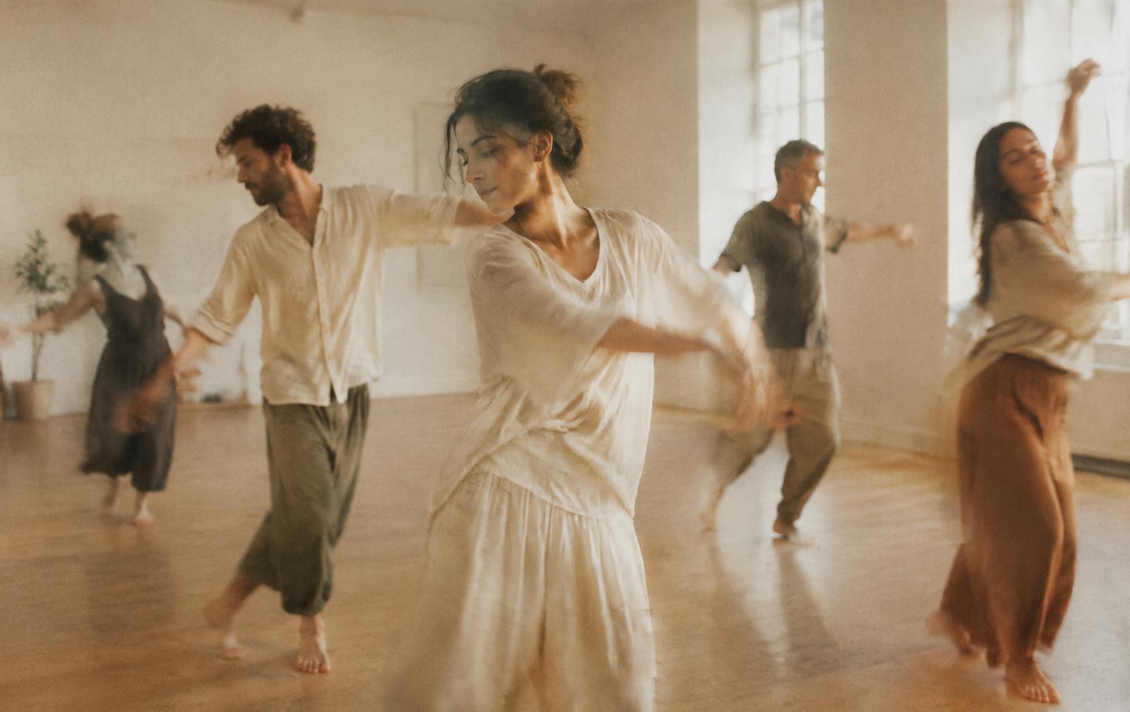 A group moving mindfully together in a bright studio